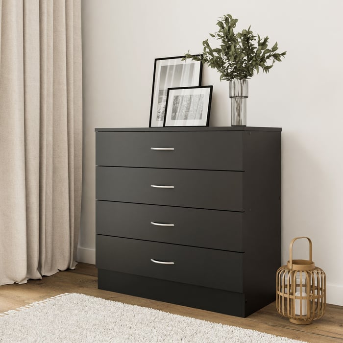 The chest of drawers ESSENTIAL black in a modern living room.