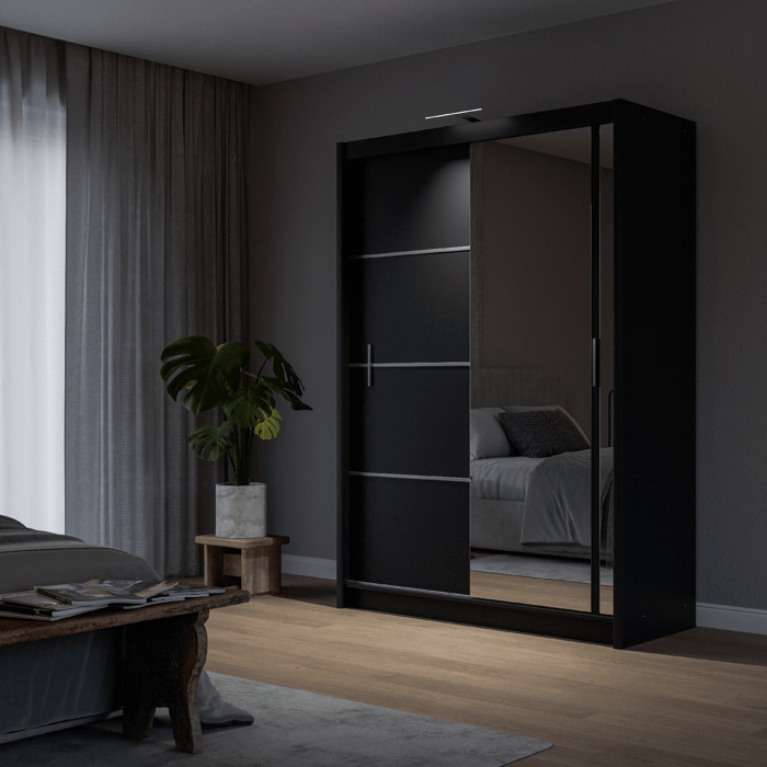 The sliding door VISTA 150cm black displaying the LED in a cosy bedroom.