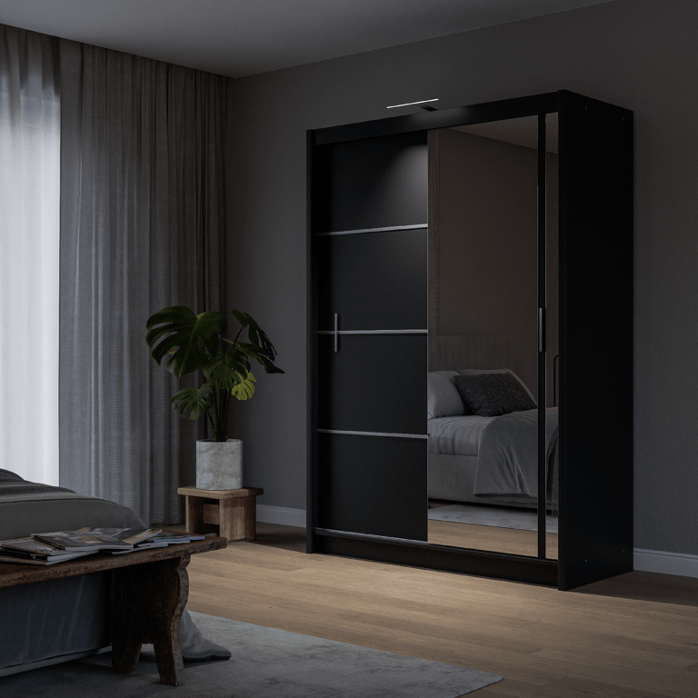 The sliding door VISTA 150cm black displaying the LED in a cosy bedroom.
