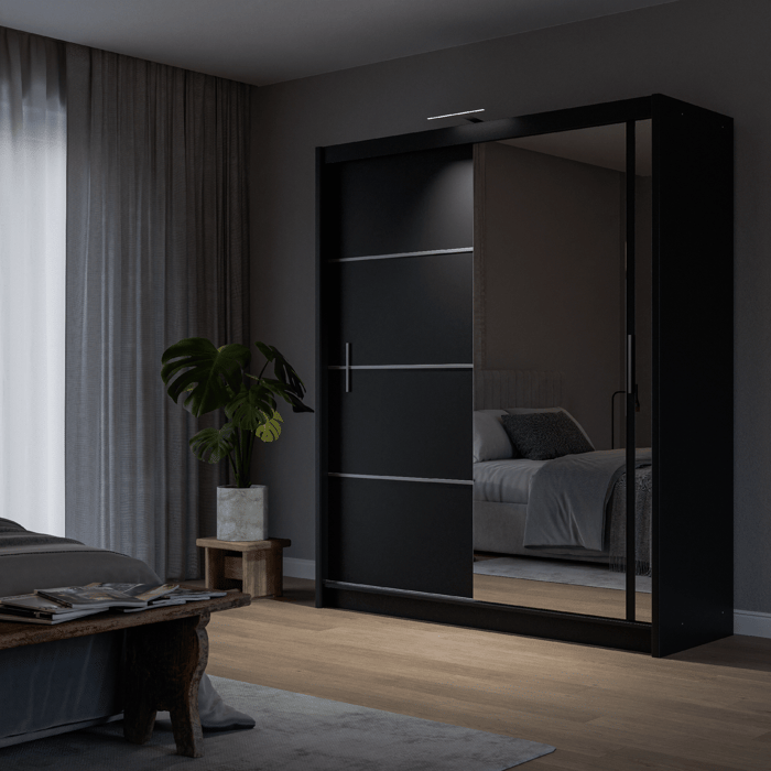 The sliding door VISTA 180cm black displaying the LED in a cosy bedroom.