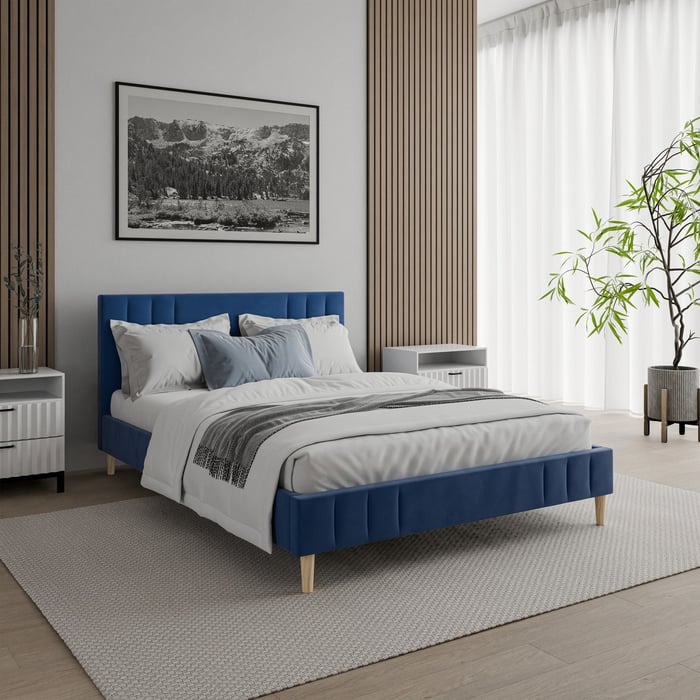 The upholstered bed Jaxon in navy blue.