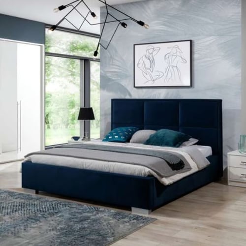Stylish bedroom featuring a navy upholstered bed, abstract wall art, modern chandelier, and floor-to-ceiling windows