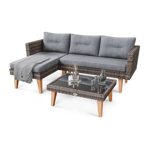 Rattan corner garden sofa with grey cushions and matching glass-top coffee table