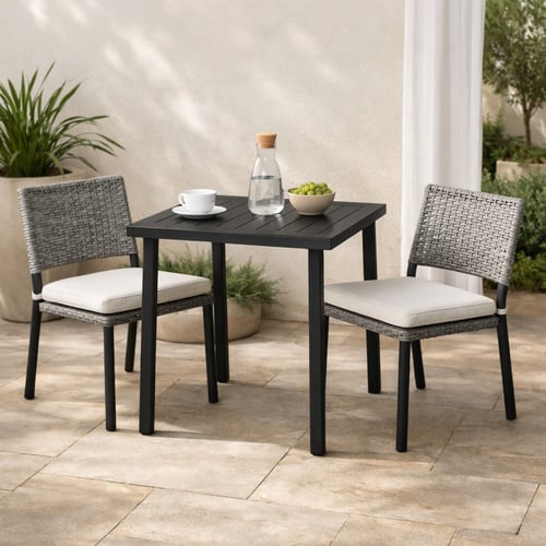 Modern black metal bistro set with two grey woven chairs and cushions on a patio – stylish and compact, ideal choice among the best bistro sets for small outdoor spaces.