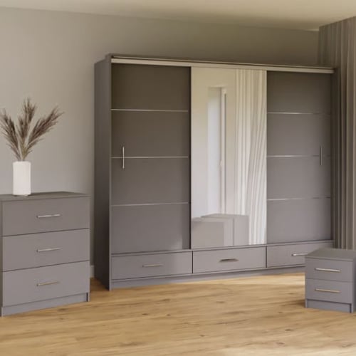 Modern grey bedroom with matching wardrobe, chest of drawers, and bedside unit on wooden flooring