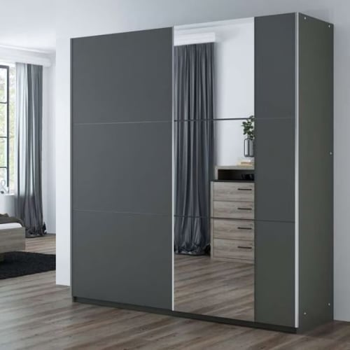 Modern sliding wardrobe with mirrored and dark grey panels, fitted in a bedroom with wooden flooring