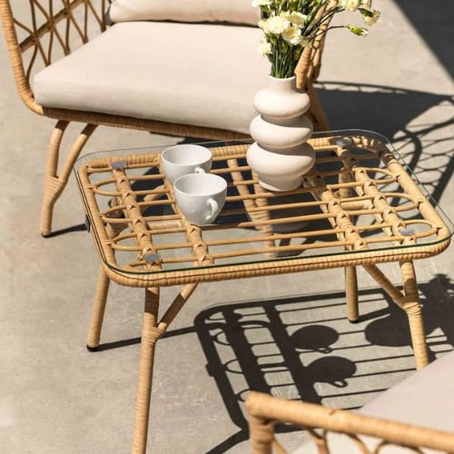 mall rattan garden coffee table with glass top, ceramic vase, and two cups in outdoor seating area