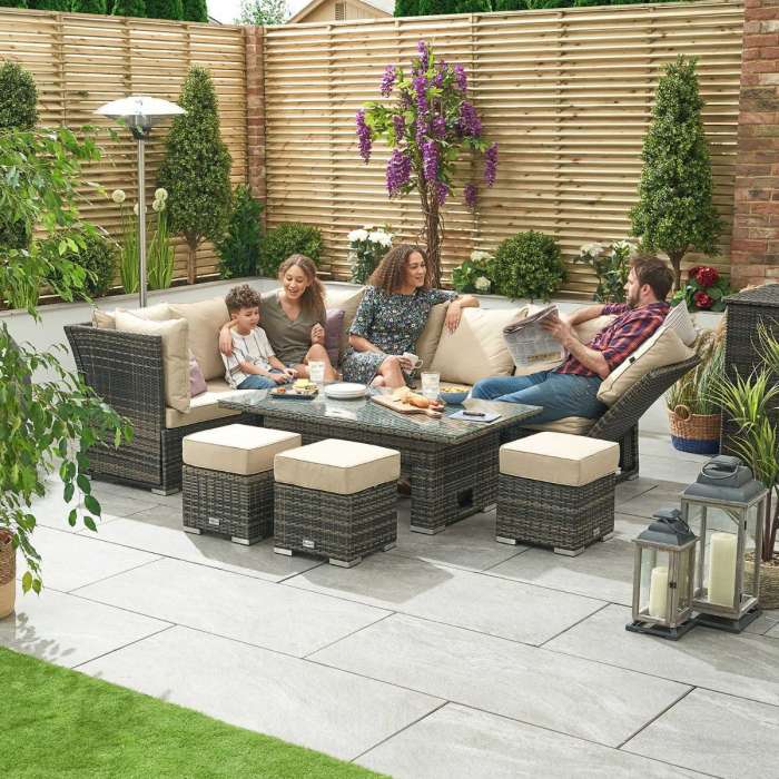 Cambridge Left Hand Rattan Corner Dining Set with Rising Table & Reclining Sides - Brown with a family sitting on it