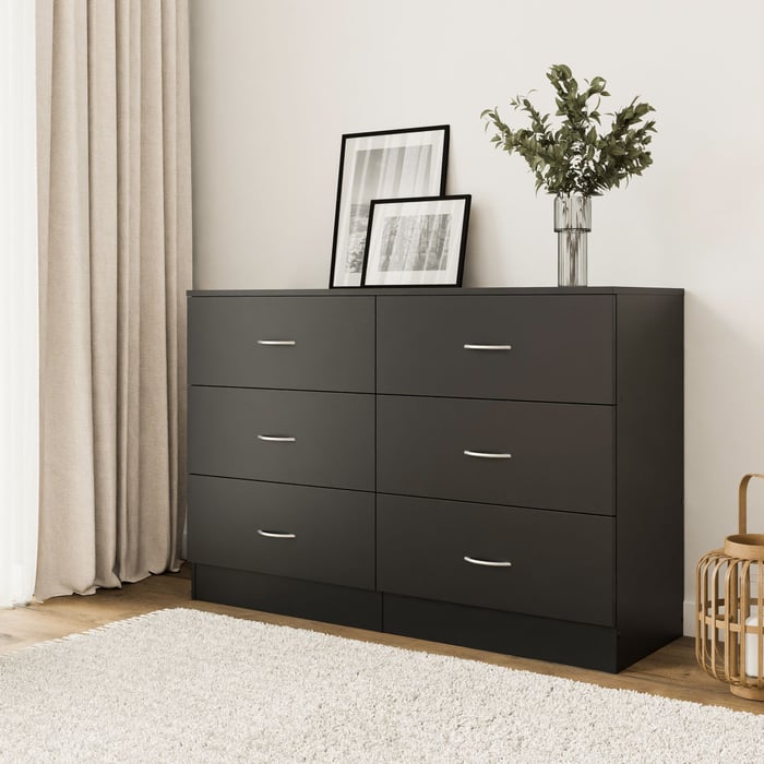 The ESSENTIAL chest of drawers 120 black in a cosy living room.